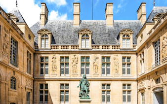 Main courtyard of Carnavalet Museum with Louis XIV statue, Paris city center, France.