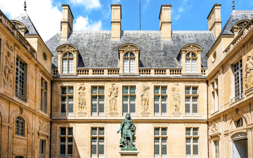 Main courtyard of Carnavalet Museum with Louis XIV statue, Paris city center, France.