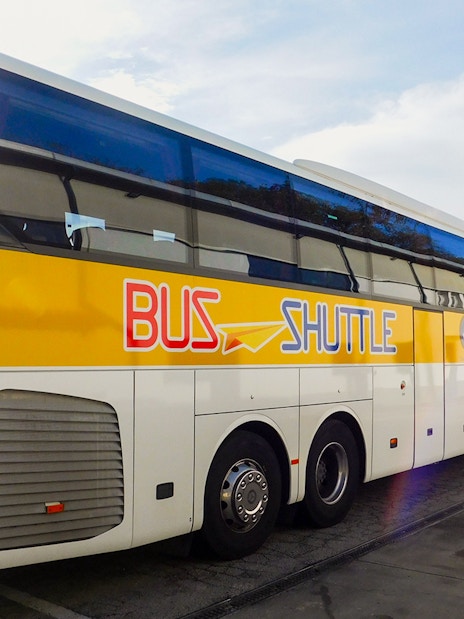 SIT Bus Shuttle parked at a station, ready for passenger boarding.