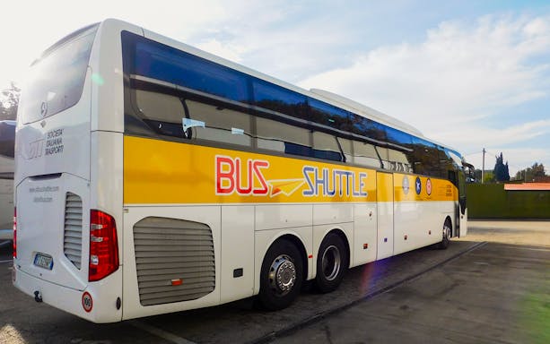 SIT Bus Shuttle parked at a station, ready for passenger boarding.