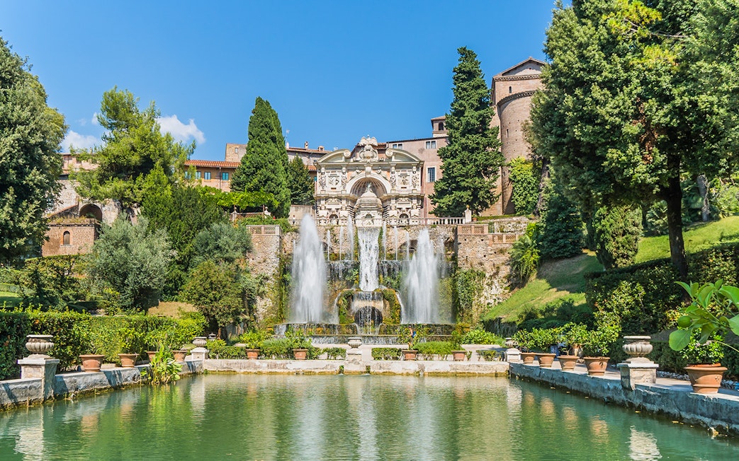 Fountain and gardens at Villa d'Este in Tivoli, Italy, with cascading water and lush greenery.
