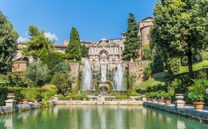 Fountain and gardens at Villa d'Este in Tivoli, Italy, with cascading water and lush greenery.