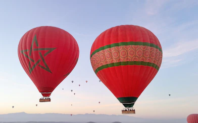 Hot air balloons over Marrakesh at sunrise, featuring Moroccan designs.