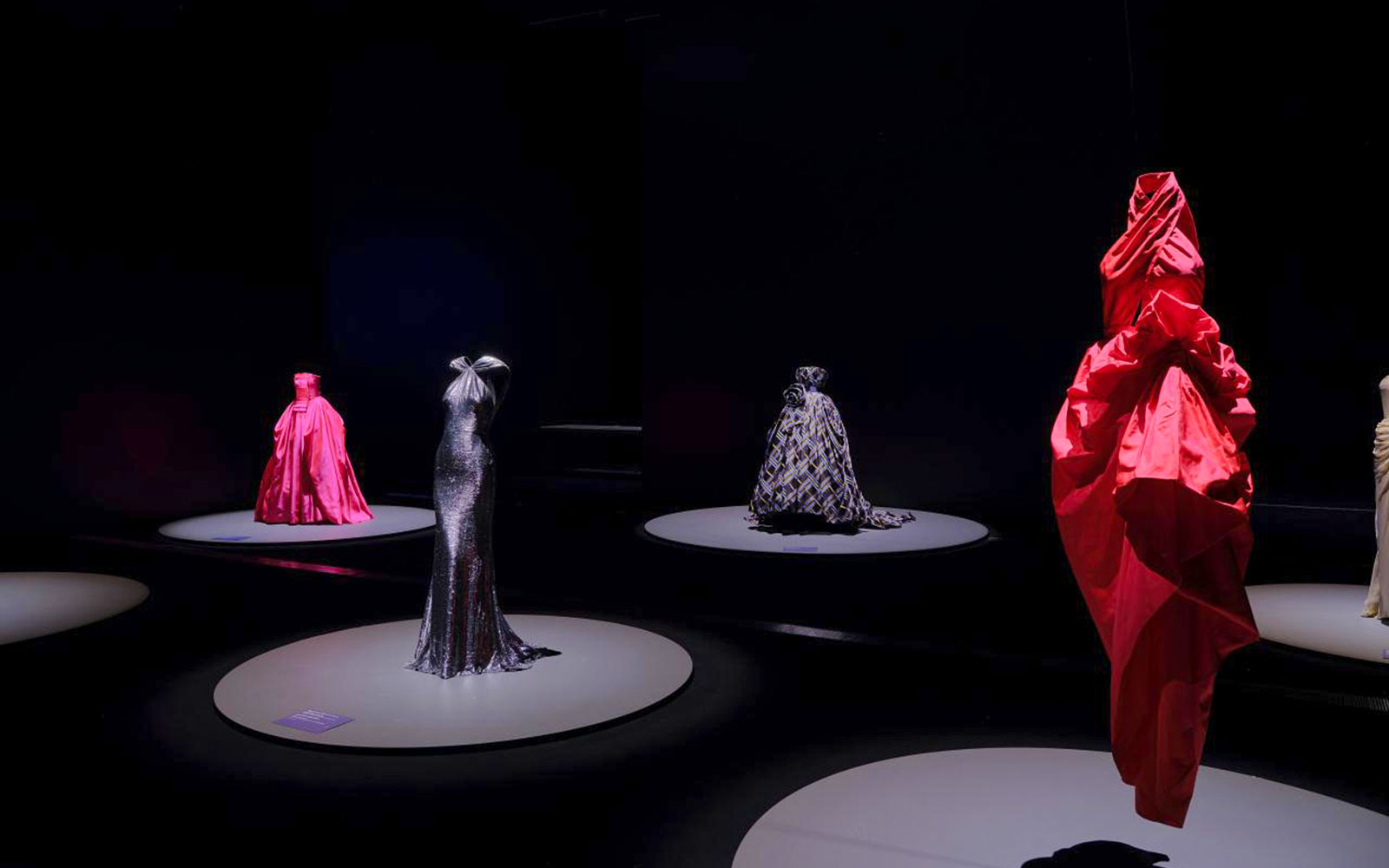 Martin Grant Exhibition showcasing elegant gowns on display platforms.