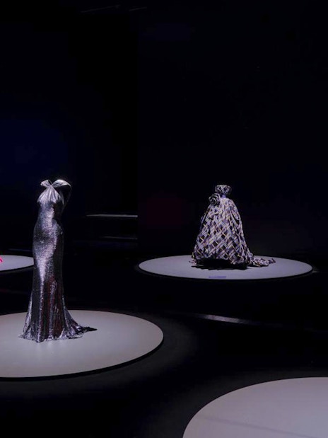 Martin Grant Exhibition showcasing elegant gowns on display platforms.