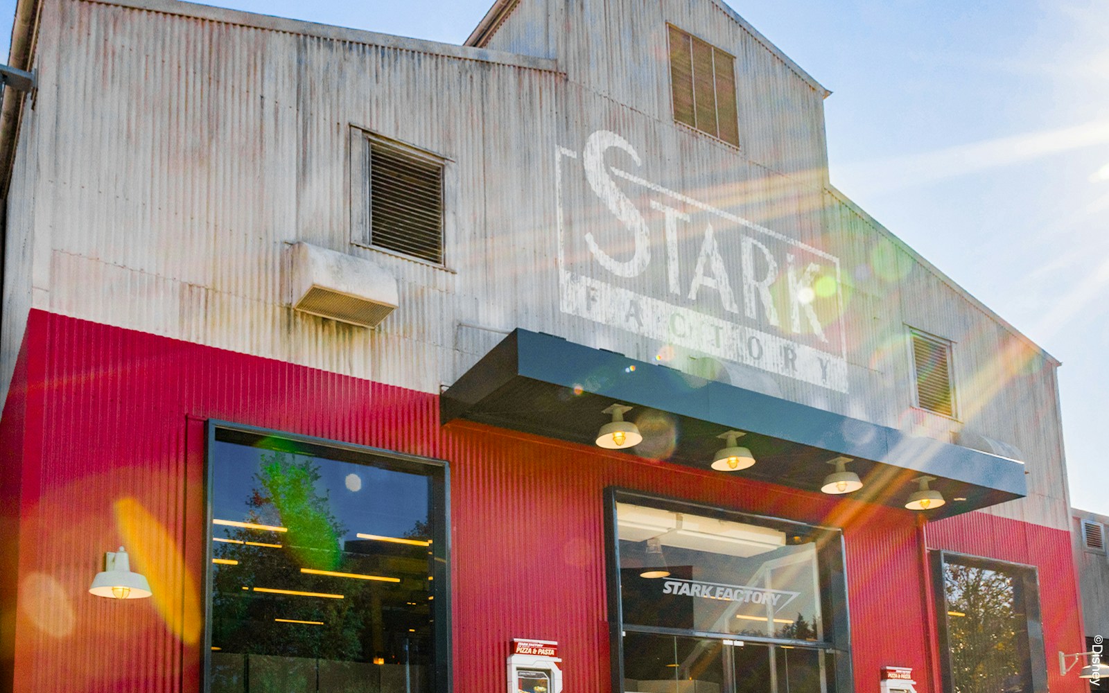 Stark Factory restaurant exterior at Disneyland Paris with themed decor and dining area.