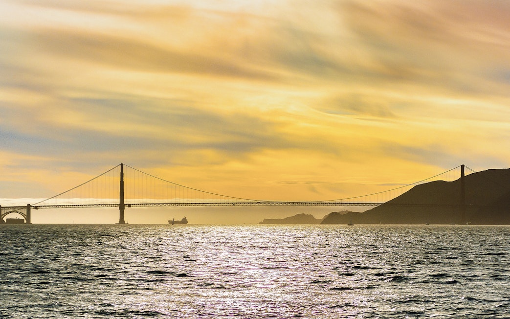 Golden Gate Bridge at sunset viewed from California Sunset Cruise.