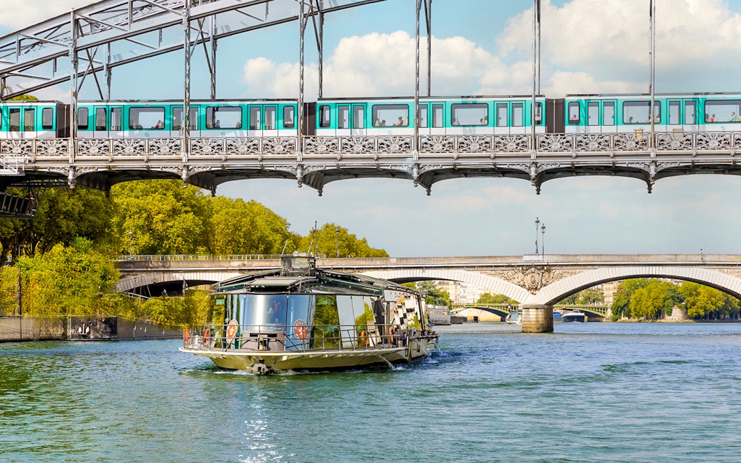 Seine River cruise boat near Paris bridges, starting at the Eiffel Tower.