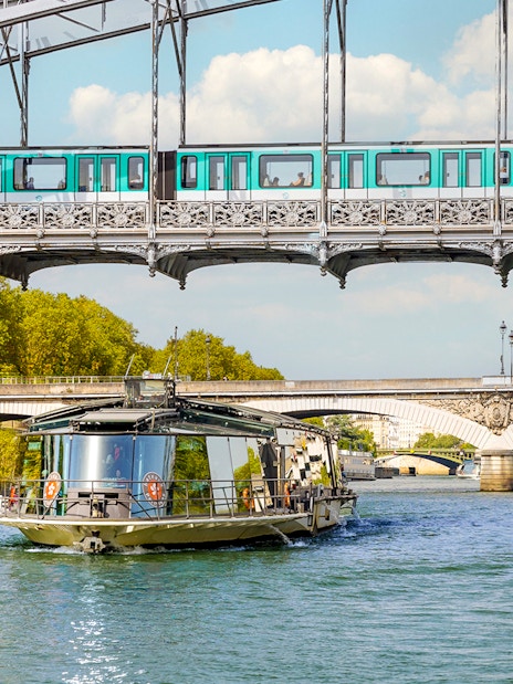 Seine River cruise boat near Paris bridges, starting at the Eiffel Tower.