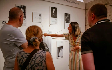 Guide explaining exhibits at the Egyptian Museum in Turin to visitors.