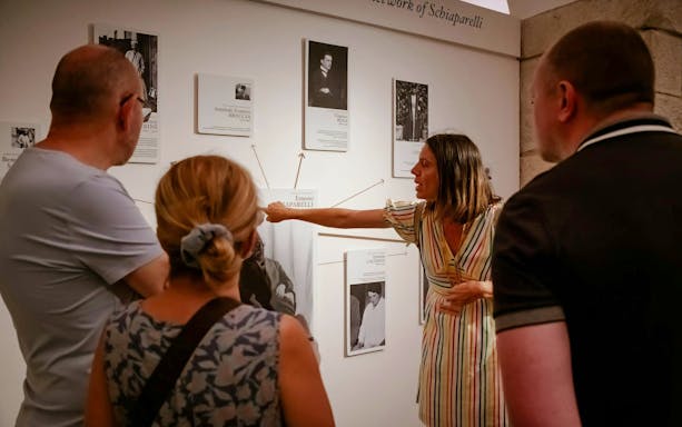 Guide explaining exhibits at the Egyptian Museum in Turin to visitors.