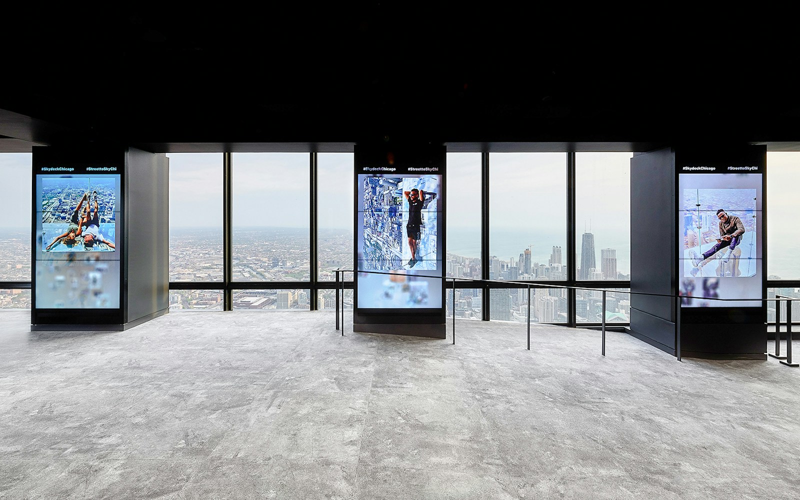 View from Skydeck at Willis Tower, Chicago, overlooking city skyline and Lake Michigan.