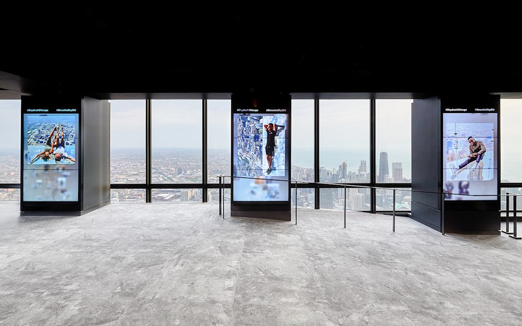 View from Skydeck at Willis Tower, Chicago, overlooking cityscape and Lake Michigan.