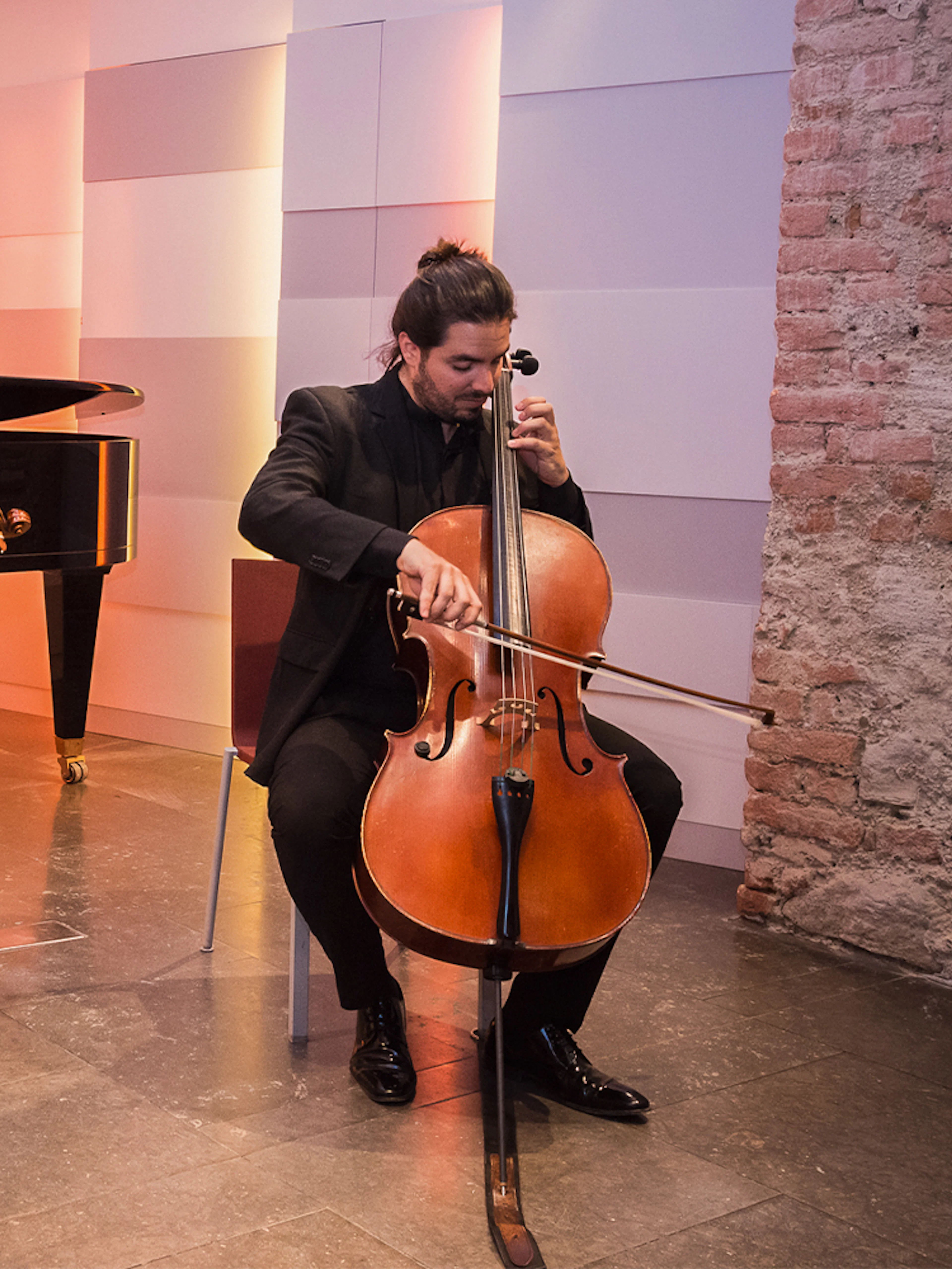 Musicians performing with violin, cello, and piano at Mozarthaus concert in Vienna.