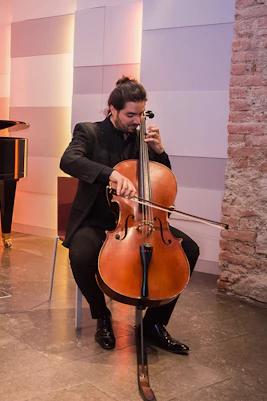 Musicians performing with violin, cello, and piano at Mozarthaus concert in Vienna.