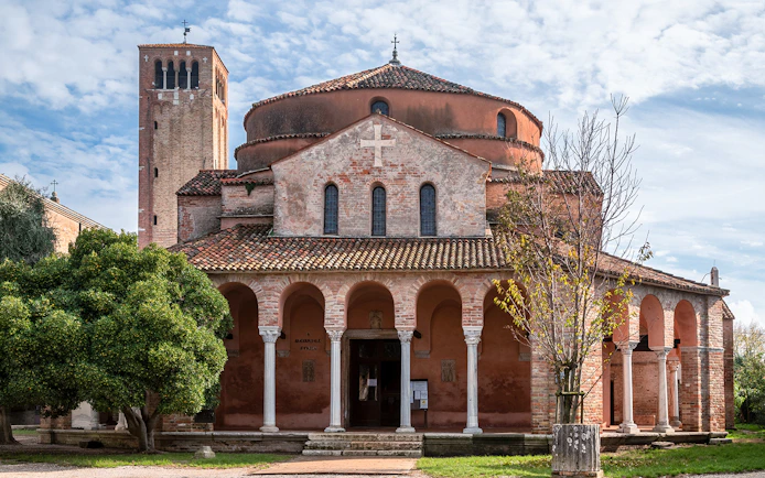 Chiesa di Santa Fosca with arched portico and bell tower, Torcello, Italy.