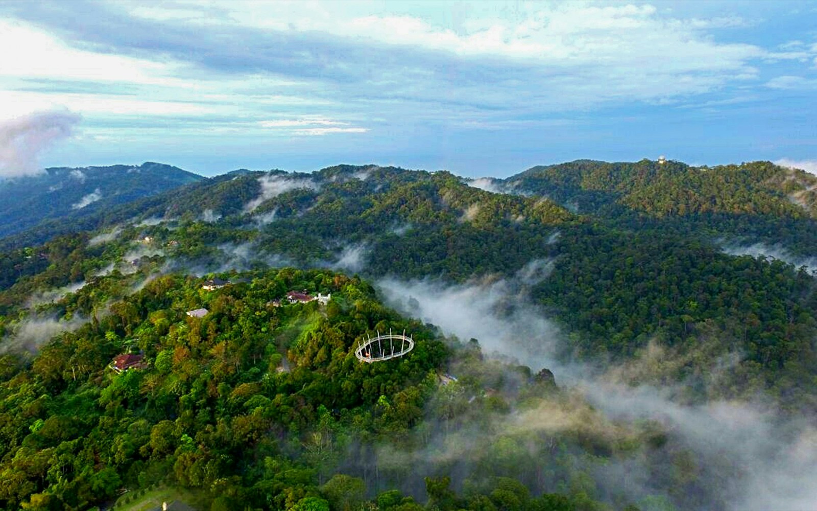 Panoramic view of Habitat Penang Hill with lush greenery and clear blue sky in Malaysia