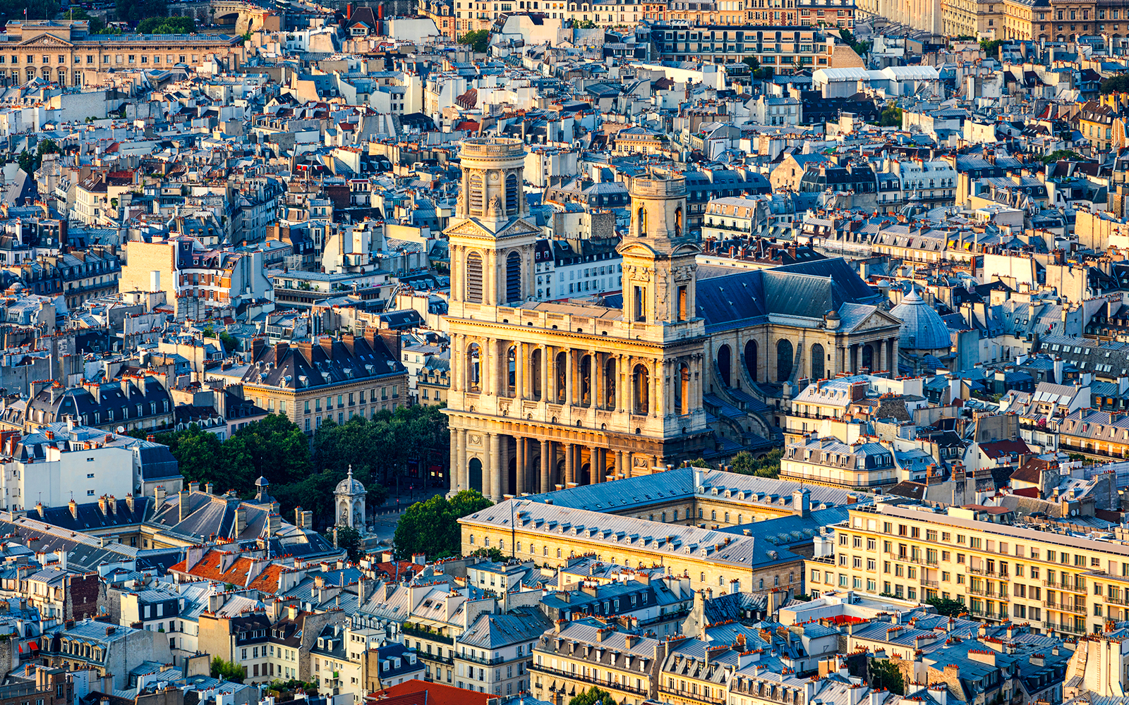 Aerial view of St Sulpice Church surrounded by Parisian rooftops.