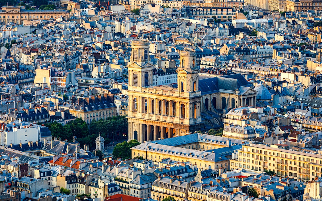 Aerial view of St Sulpice Church surrounded by Parisian rooftops.