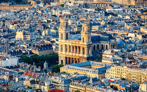 Aerial view of St Sulpice Church surrounded by Parisian rooftops.