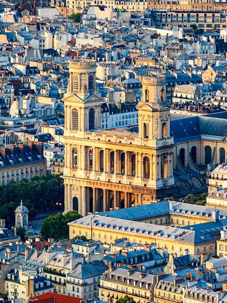 Aerial view of St Sulpice Church surrounded by Parisian rooftops.