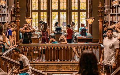 Tourists exploring the interior of Lello Library in Porto, Portugal.