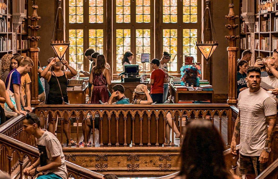 Tourists exploring Lello Library in Porto, Portugal.