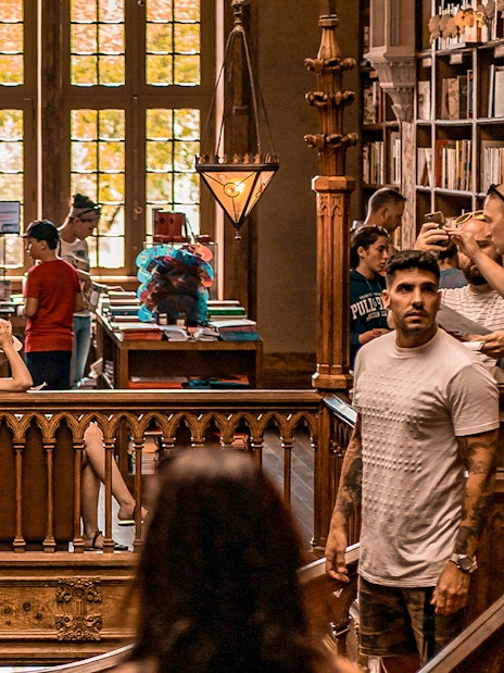 Tourists exploring the interior of Lello Library in Porto, Portugal.
