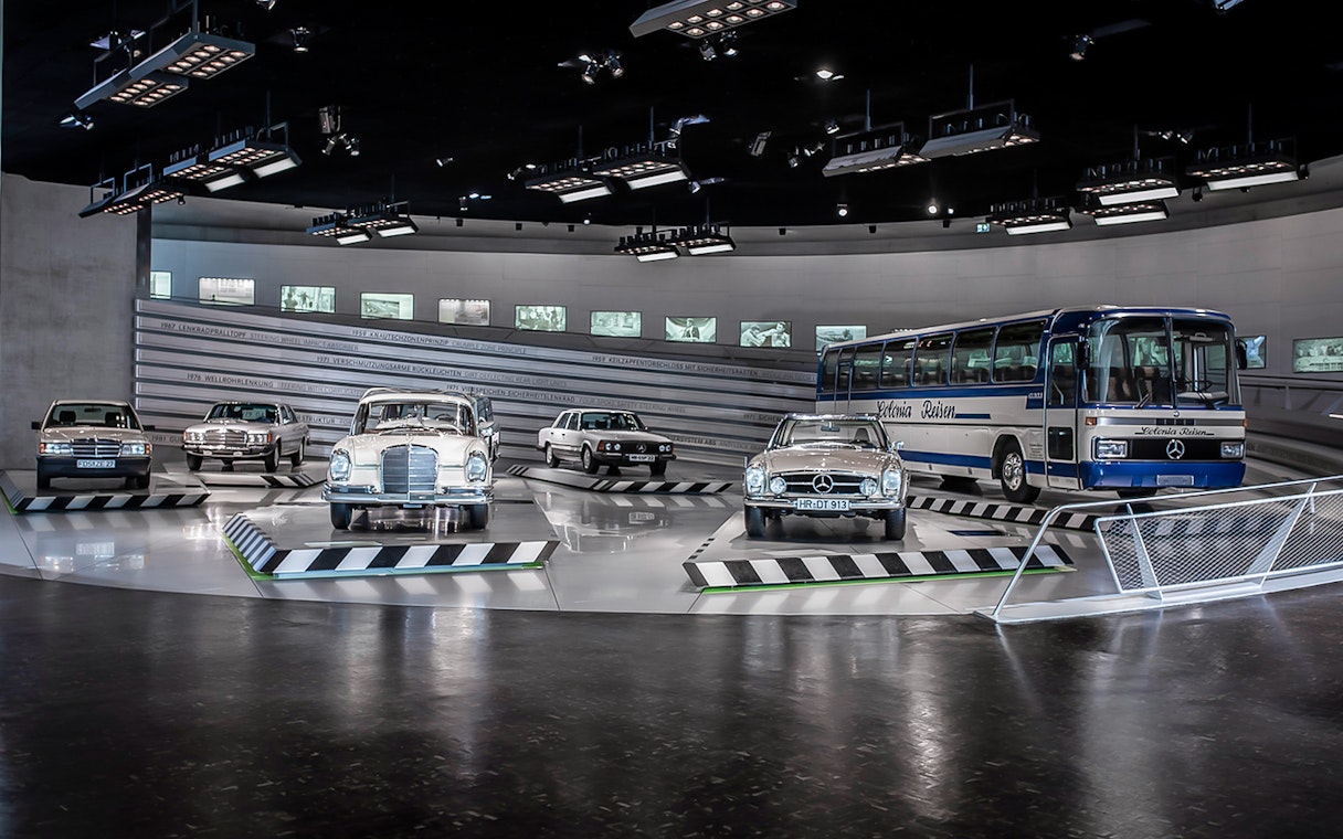 Classic Mercedes-Benz vehicles displayed inside Mercedes-Benz Museum.