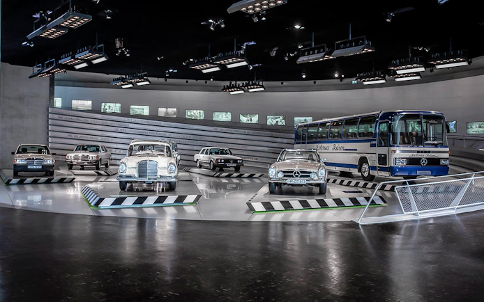 Classic Mercedes-Benz vehicles displayed inside Mercedes-Benz Museum.