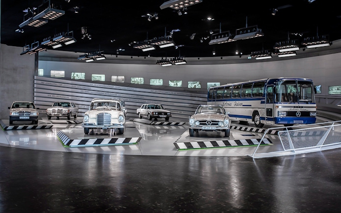 Classic Mercedes-Benz vehicles displayed inside Mercedes-Benz Museum.