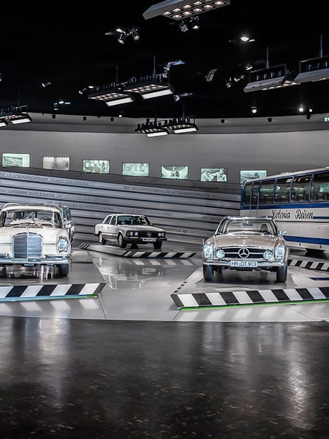 Classic Mercedes-Benz vehicles displayed inside Mercedes-Benz Museum.