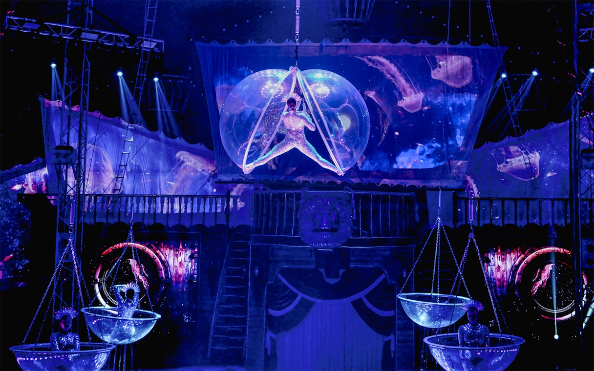 Aerial performer in a bubble at Aqua Circus Phuket show.