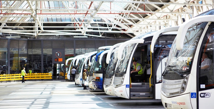 National Express coaches lined up at Luton Airport terminal.