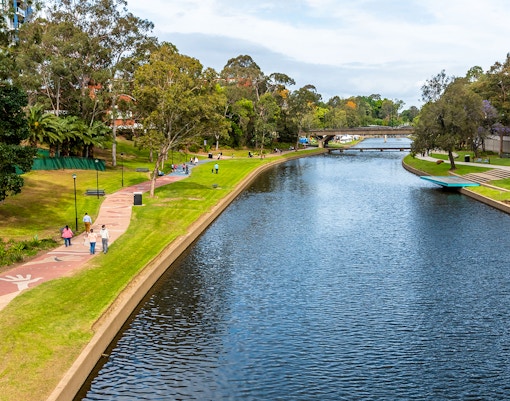 Parramatta Park historic building with lush greenery and walking paths, Sydney, Australia.