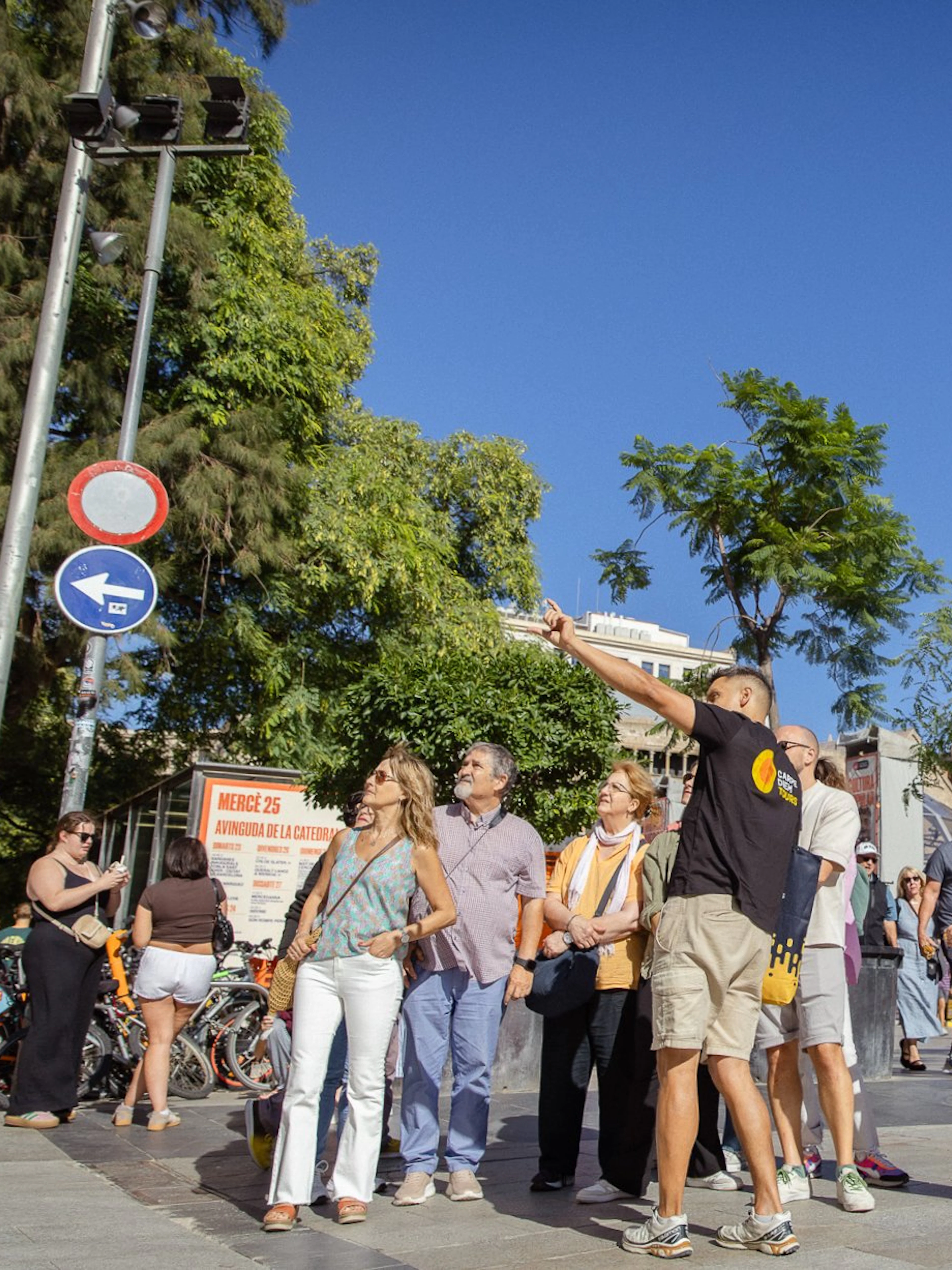 Tourists exploring the Gothic Quarter in Barcelona with the Barcelona Cathedral in the background.