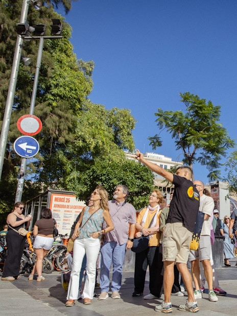 Tourists exploring the Gothic Quarter in Barcelona with the Barcelona Cathedral in the background.