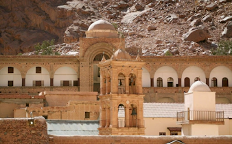 Bell tower at Saint Catherine's Monastery, Mount Sinai, with arched architecture and rocky backdrop.