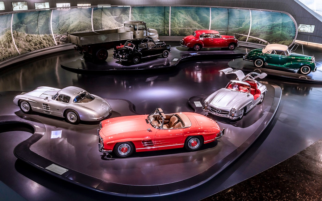 Mercedes-Benz sedans and convertibles displayed in a museum exhibit.