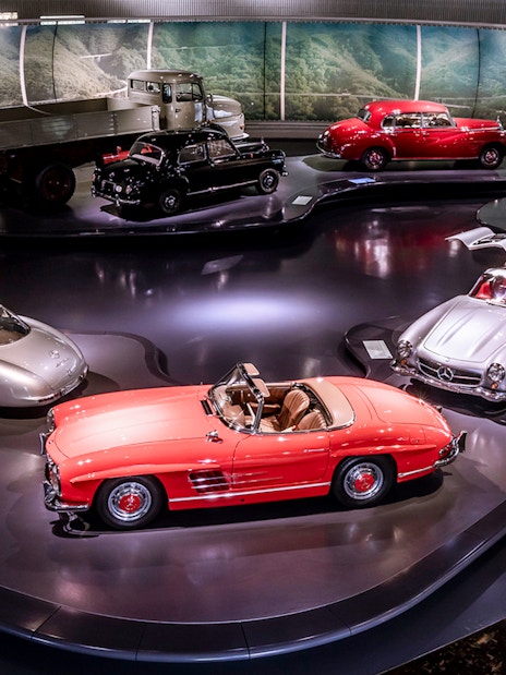 Mercedes-Benz sedans and convertibles displayed in a museum exhibit.