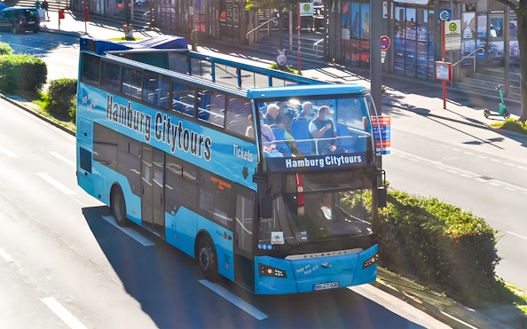 Open-top Hamburg City Tours bus on a street, part of 1-day hop-on hop-off pass.