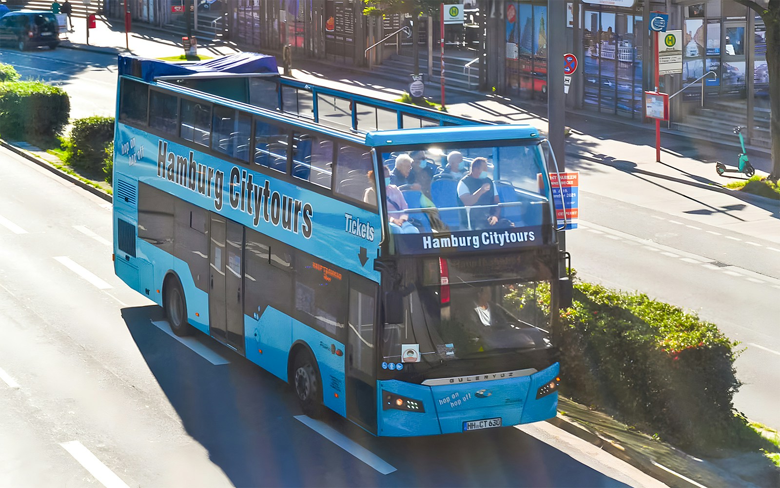 Open-top Hamburg City Tours bus on a street, part of 1-day hop-on hop-off pass.