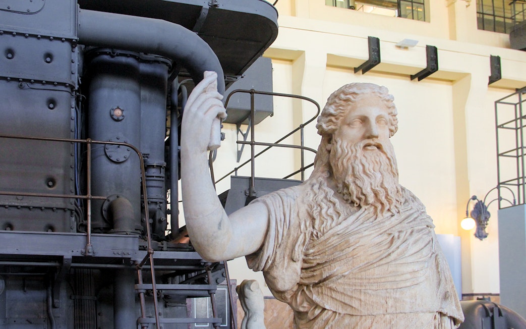 Roman sculpture at Centrale Montemartini, Rome, with industrial backdrop.