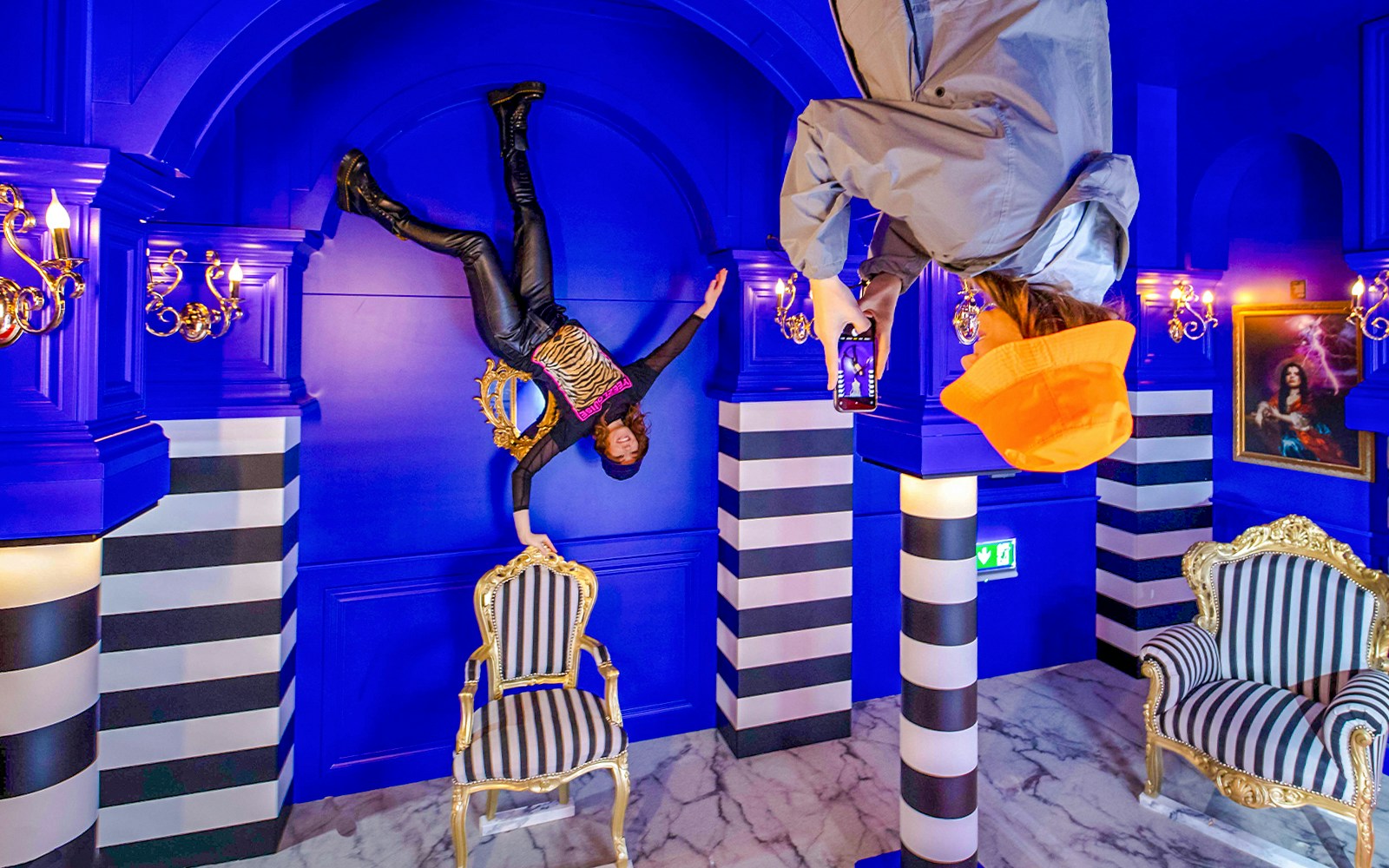 Visitors exploring Royal Room at the Upside Down Amsterdam