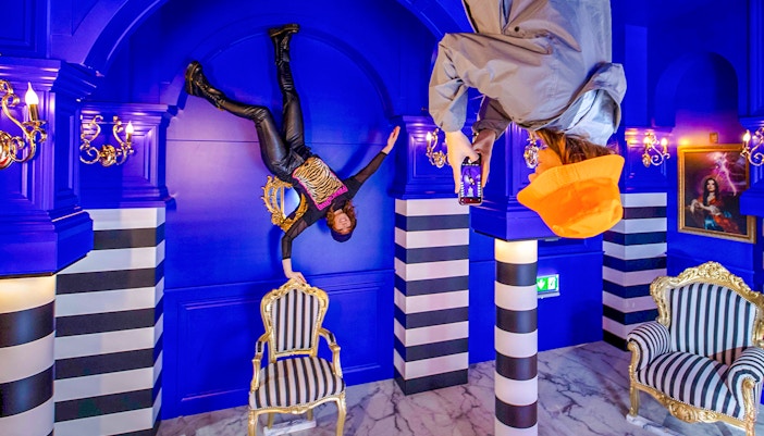 Visitors in Royal Room at Upside Down Amsterdam Museum exploring interactive exhibits.