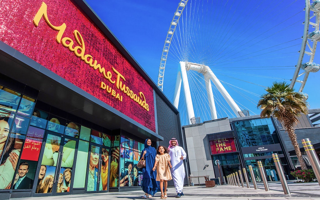 Madame Tussauds Dubai entrance with Ferris wheel in the background.
