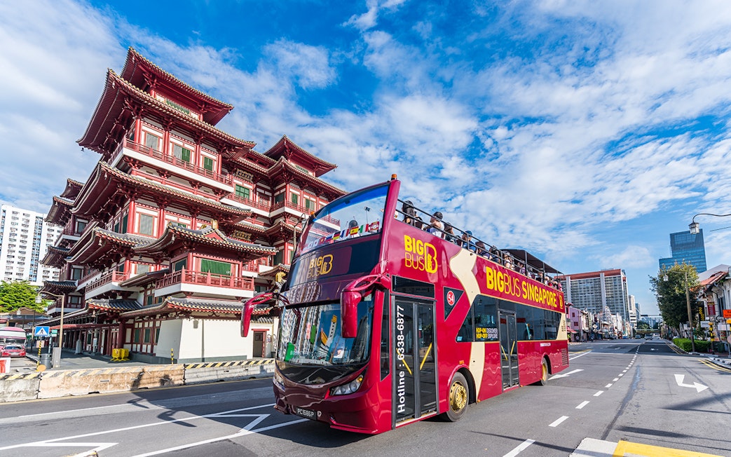 Tourists on a Singapore Hop-On-Hop-Off bus passing the Buddha Tooth Relic Temple.