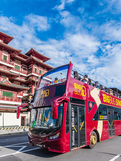 Tourists on a Singapore Hop-On-Hop-Off bus passing the Buddha Tooth Relic Temple.