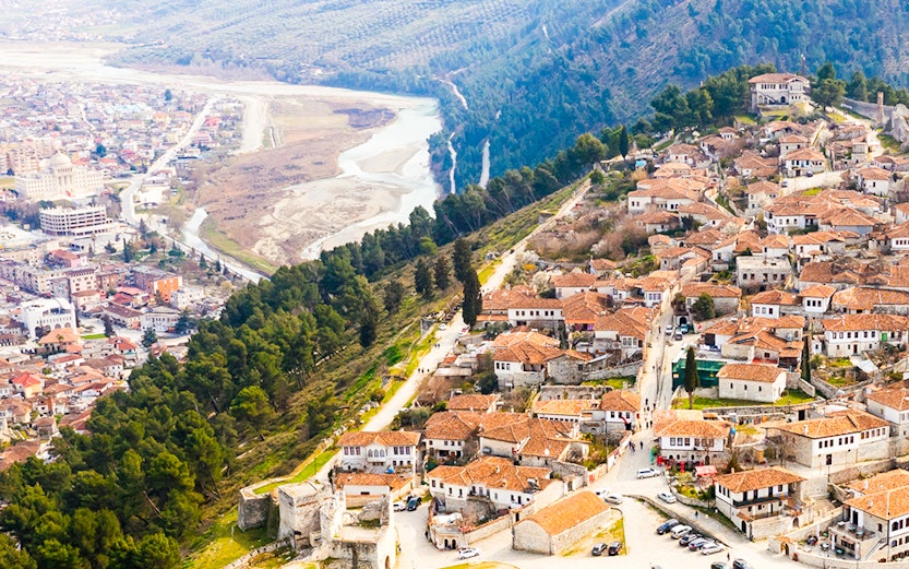 Aerial view of Berat, Albania with castle walls and tiled roofs.