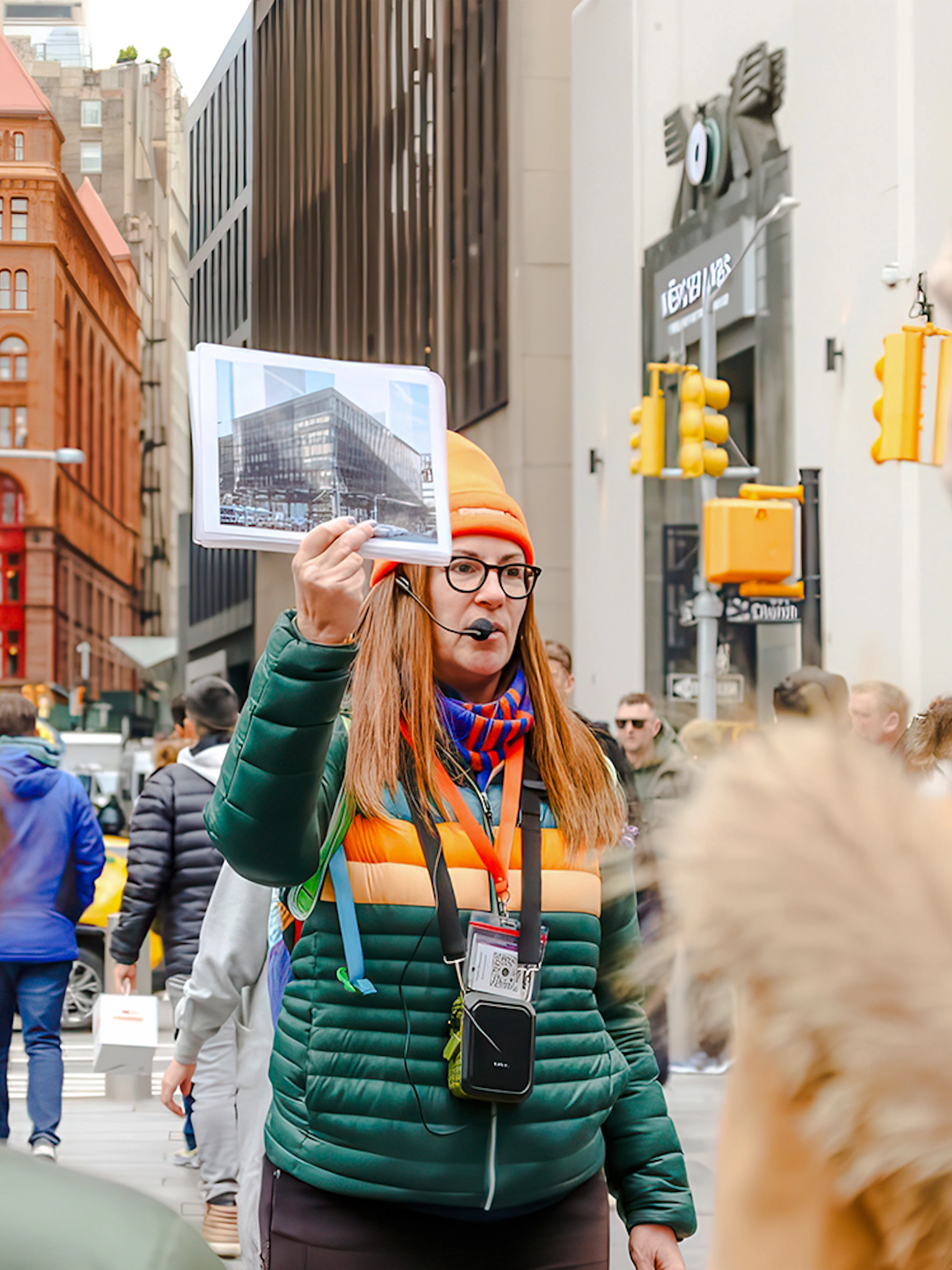 Tour guide in New York City showing a photo of the original World Trade Center.